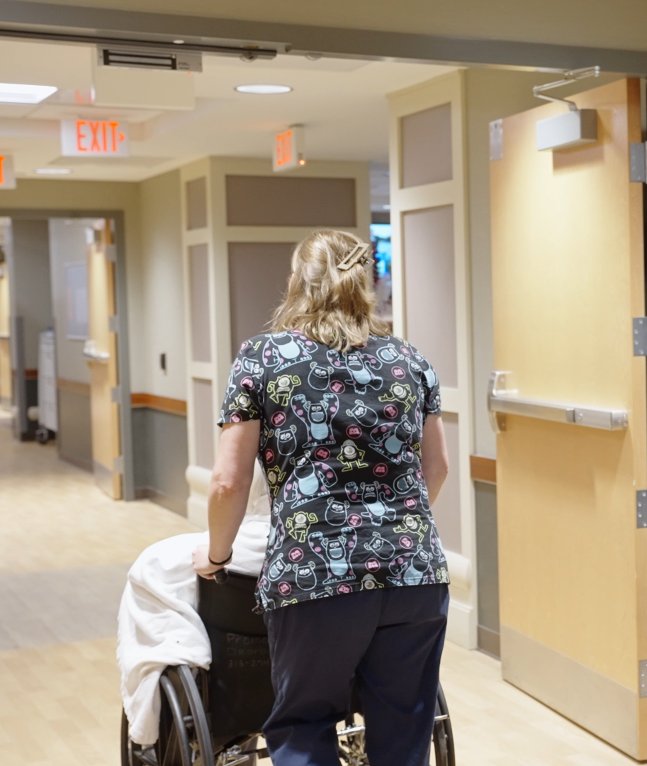 A nurse walking down a corridor at Monroe Springs Rehab